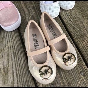 Gold slip on flat with gold MK on toe.